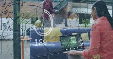 Woman Working with Futuristic HUD Laptop in Coworking Space for Tech Collaboration