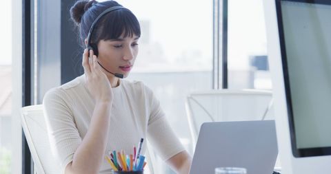 Young Businesswoman Using Headset in Modern Office Environment - Download Free Stock Images Pikwizard.com