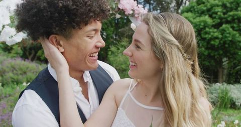 Diverse Couple Embracing in Outdoor Wedding Ceremony