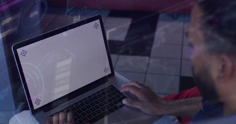 Designer tapping laptop trackpad launching hud ui mockup with crop marks and overlay