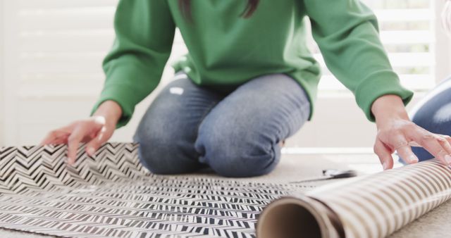 Person Kneeling on Floor Wrapping Gift with Patterned Paper - Download Free Stock Images Pikwizard.com