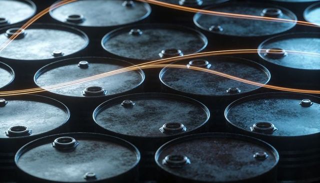 Industrial oil drums showcasing rusted lids with sweeping orange light trails