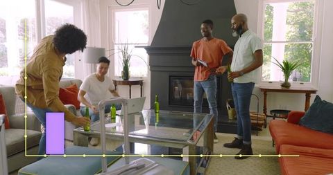 Roommates unpacking luggage and sharing drinks in bright modern living room with fireplace