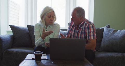 Senior Couple Discussing Finances at Home Using Laptop - Download Free Stock Images Pikwizard.com