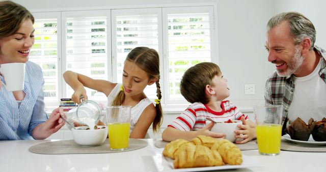 Happy Family Having Breakfast Together at Bright, Modern Kitchen Table - Download Free Stock Images Pikwizard.com