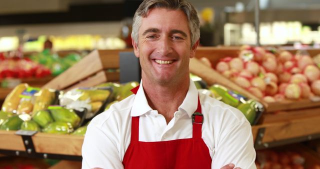 Portrait of smiling worker doing thumbs up in grocery store