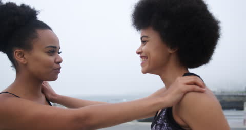 Supportive Fitness Friends Enjoying Workout by Sea