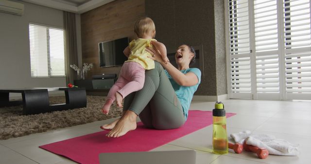 Caucasian mother playing with her baby while practicing yoga on yoga mat at home. mother's day love family parenthood childhood concept
