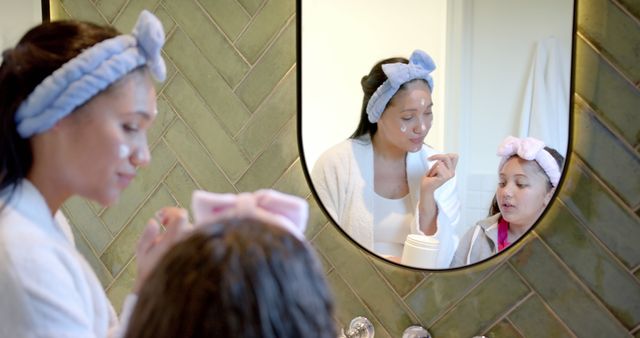 Mother and Daughter Applying Facials in Bathroom Mirror - Download Free Stock Images Pikwizard.com