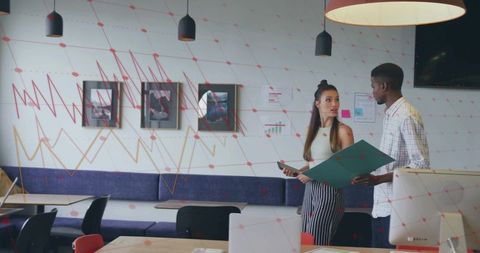 Diverse Colleagues Discussing Documents in Contemporary Office