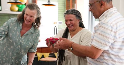 Senior Friends Gathering to Share Meal and Laughter at Home