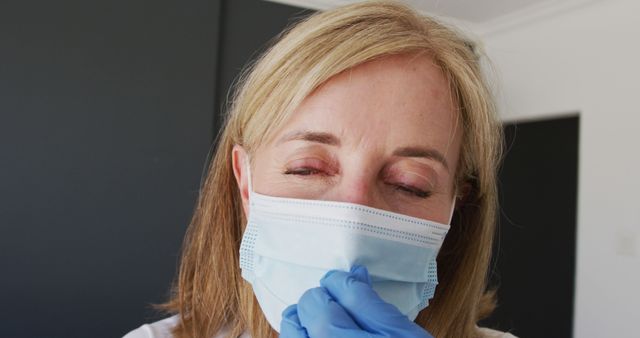 Tired Healthcare Worker Adjusting Face Mask - Download Free Stock Images Pikwizard.com