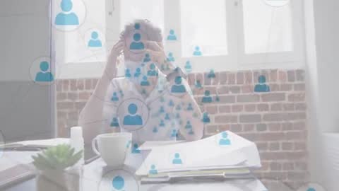 Stressed Professional in Modern Office with Network Overlay