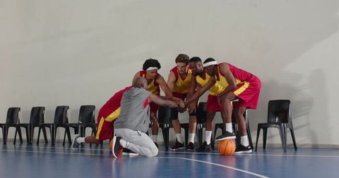 Basketball team huddle encouraging unity and motivation on court