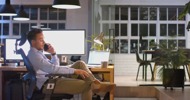 Businessman Talking on Phone in Modern Office at Night - Download Free Stock Images Pikwizard.com