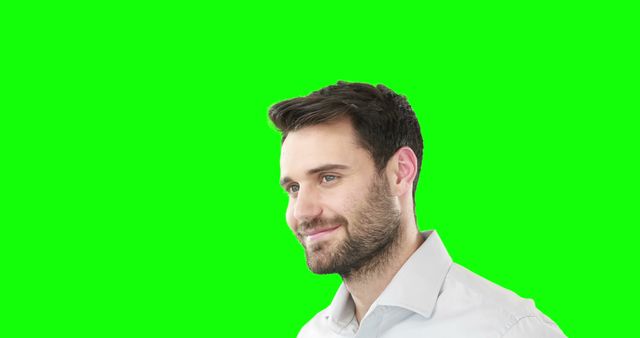 Man in business casual attire smiling against a green background. Ideal for use in advertisements, presentations, or mock-ups. Perfect for themes like business, positivity, and professional appearance.