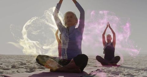 Group of Seniors Practicing Yoga on Beach