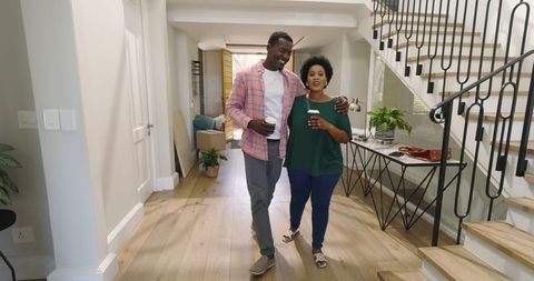 Joyful African American Couple Sharing Coffee in Stylish Home