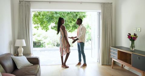 African american couple engaging in conversation in airy living room