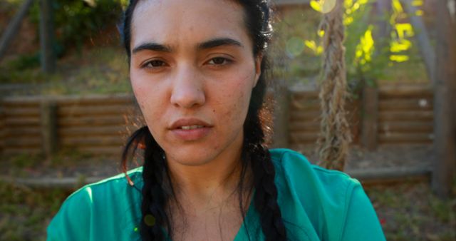 Serious Woman with Braided Hair in Outdoor Setting - Download Free Stock Images Pikwizard.com