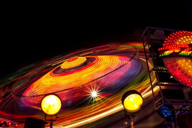 Vibrant Spinning Amusement Park Ride at Night - Download Free Stock Photos Pikwizard.com