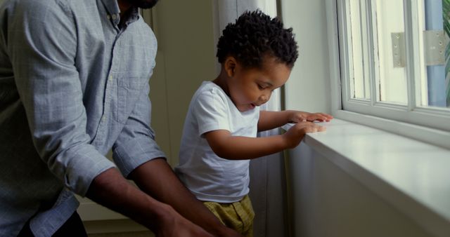 Father and Son Spending Quality Time at Home Looking Out Window - Download Free Stock Images Pikwizard.com