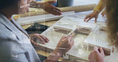 Architects designing building with data visualization overlay