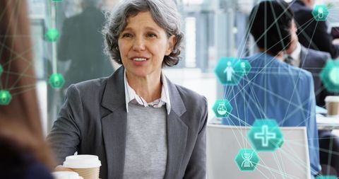 Senior Woman in Business Meeting with Tech Icons