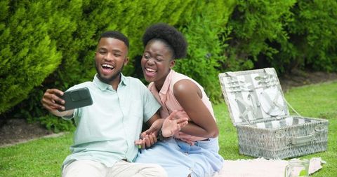 Couple Taking Selfie During Sunny Picnic in Park