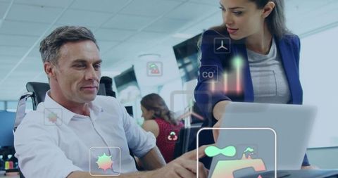 Team collaborating over laptop with augmented analytics overlay in modern open-plan office