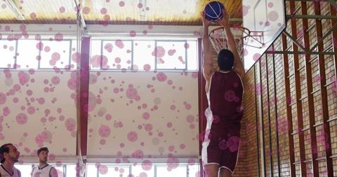Athlete dunking basketball in vibrant school gym environment
