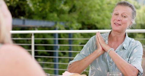 Joyful middle-aged women enjoying outdoor conversation