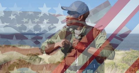 Patriotic african american hiker in nature with layered american flag