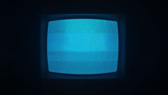 Retro CRT TV Displaying Eerie Blue Static in Dark Room
