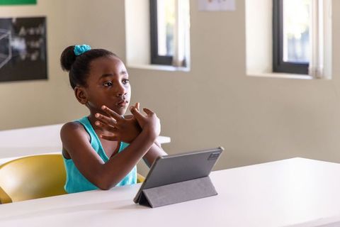 African American Girl Using Tablet in Classroom Learning Geometry and Sign Language