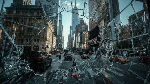 Urban breaking news chaos: cityscape through broken glass in bustling metropolis