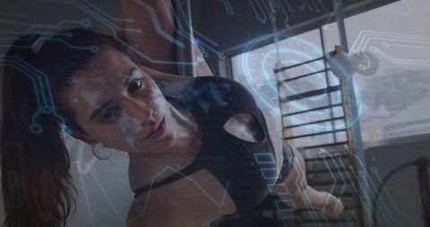 Woman practicing side plank with digital interface overlay in modern gym