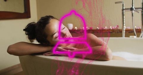 Woman Relaxing in Bathtub with Tealight Candles