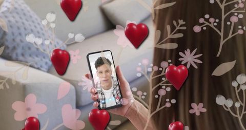 Woman holding smartphone sharing romantic video call with hearts and floral overlays