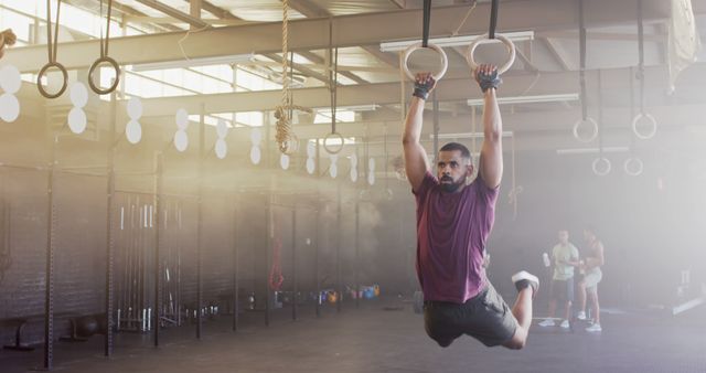 Determined Man Performing CrossFit Rings Exercise in a Gym - Download Free Stock Images Pikwizard.com