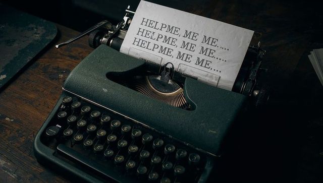 Vintage typewriter with help me plea on distressed paper for thriller and horror themes