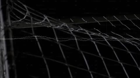 Goalkeeper Anticipating Save with Digital Overlay in Night Match