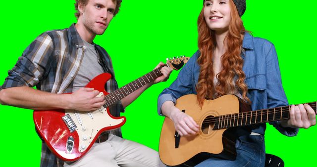 Young male and female musicians each playing electric and acoustic guitars on a green screen background. Ideal for video production, music tutorials, online lessons, promotional material, and editing various backgrounds in post-production.