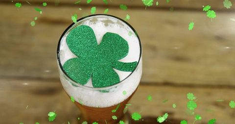 St patrick's day beer pint with glitter shamrock on foam celebrating pub cheer