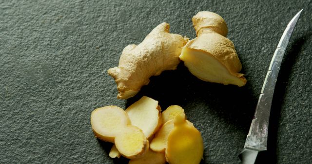 Fresh Ginger Root and Sliced Pieces on Dark Slate Surface - Download Free Stock Images Pikwizard.com