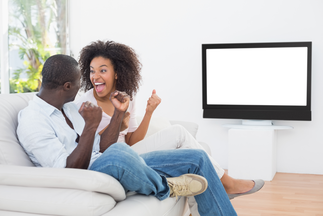 Joyful Couple Cheering In Living Room With Transparent Television Screen - Download Free Stock Videos Pikwizard.com