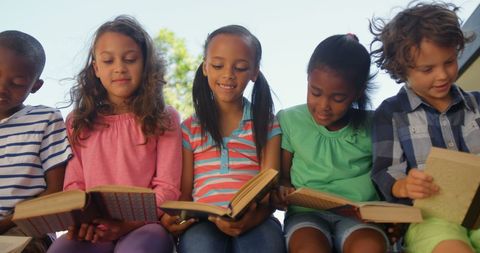 Diverse Children Enjoying Books Together in Outdoor Setting - Download Free Stock Images Pikwizard.com