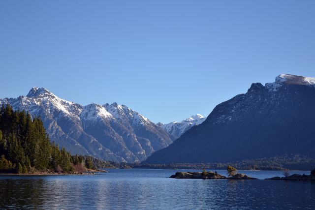 Majestic Snow-Capped Mountains and Serene Lake Under Clear Blue Sky - Download Free Stock Photos Pikwizard.com