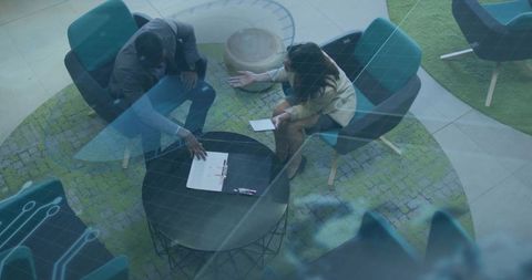 Business professionals discussing project in modern office lounge