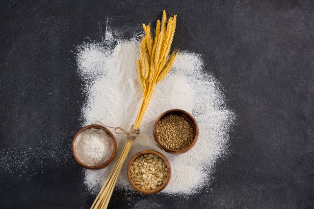 Wheat, Sesame, and Flour in Wooden Bowls on Black Surface - Download Free Stock Images Pikwizard.com